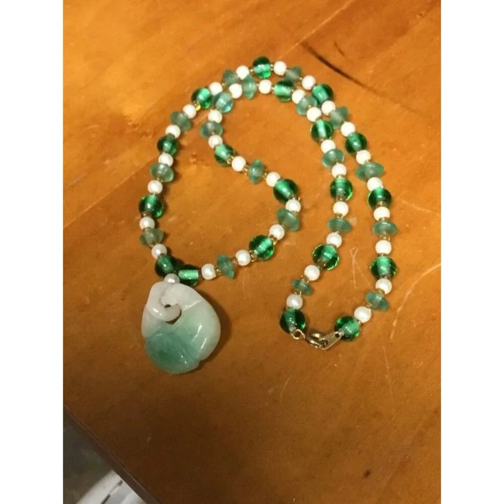 Jade and beads necklace, amazing artistry into that pendant,   Look Closer.